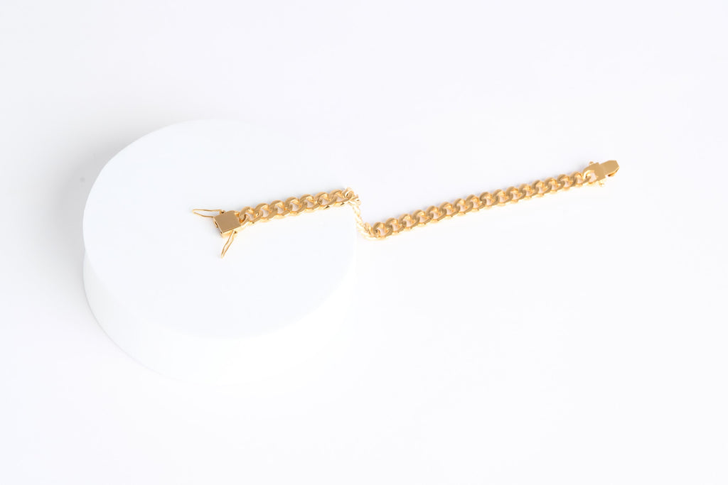 Gold chain necklace on a white background
