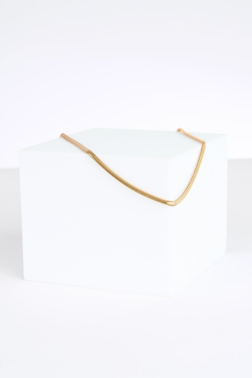 Gold necklace on a white background