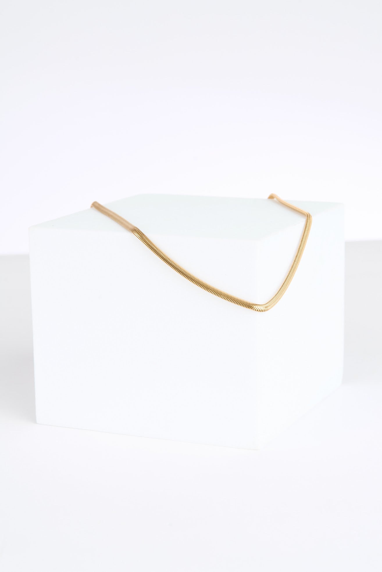 Gold necklace on a white background