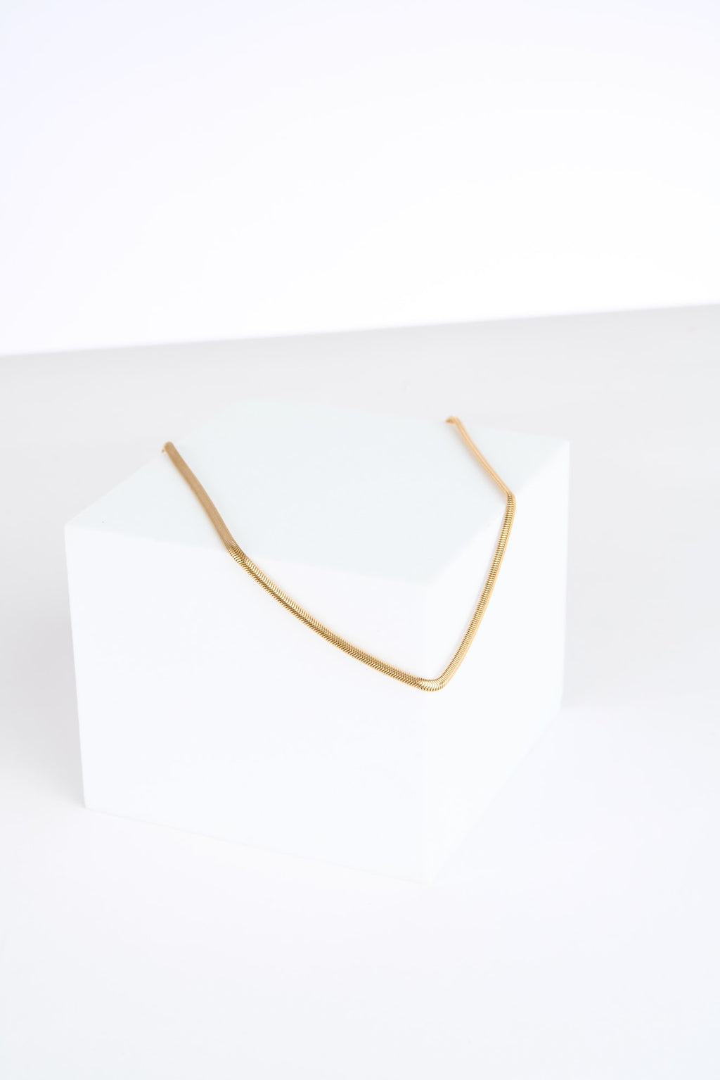 Gold necklace on a white background