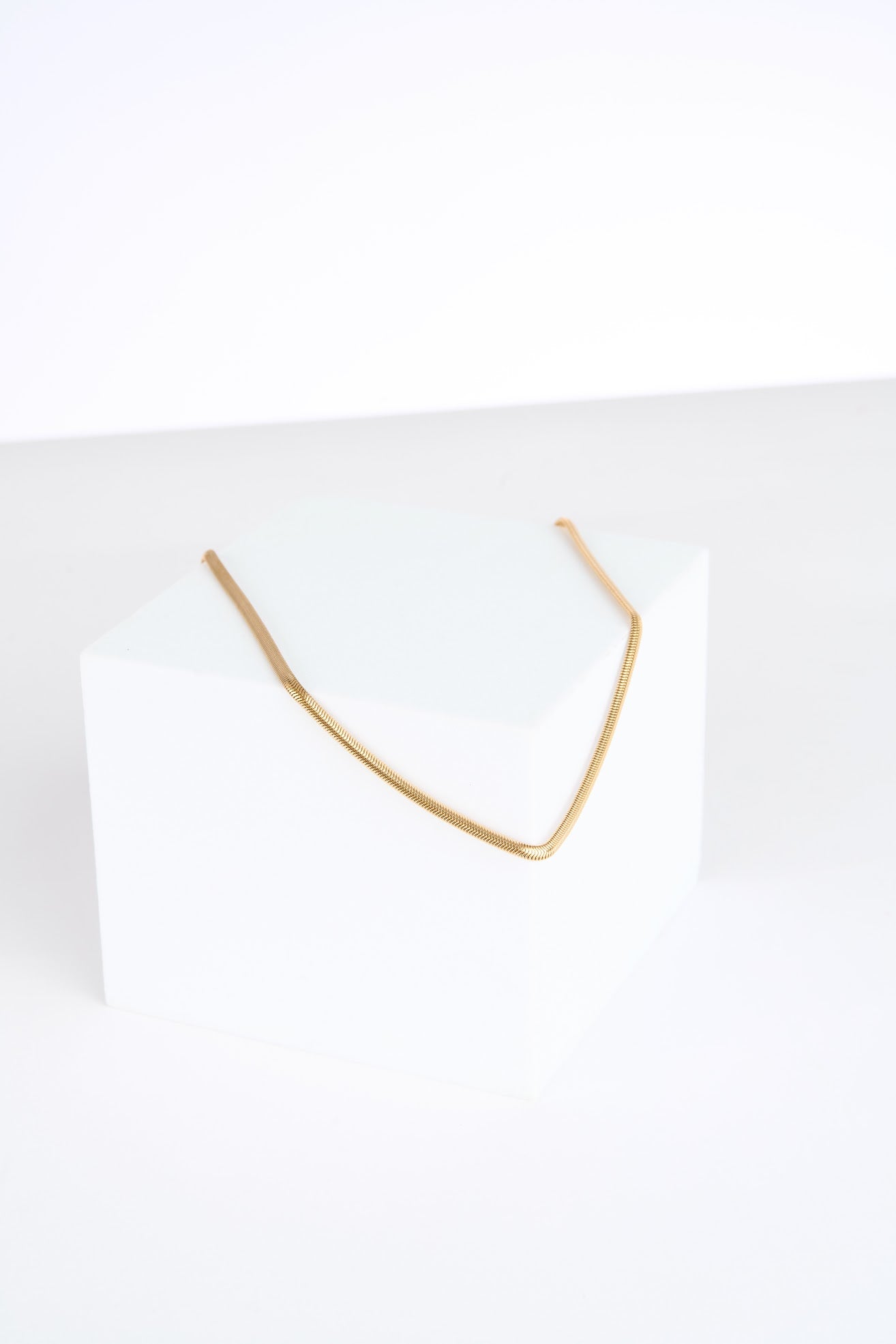 Gold necklace on a white background